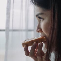 Woman eat bread with sweetened condensed milk as easy breakfast.